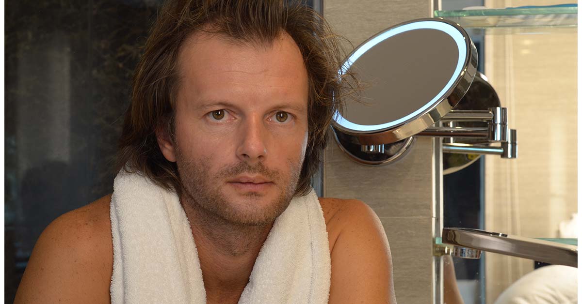 Man with thinning hair and receding hairline.